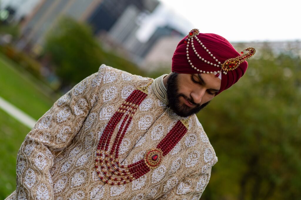 Maroon, rust and navy pags laid against an ivory sherwani